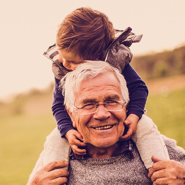 Little child on grandfather's shoulders